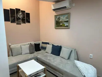 a living room with a couch and a table at Apartaments Filipopolis in Plovdiv