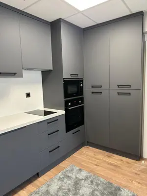 a kitchen with white cabinets and a stove top oven at Apartaments Filipopolis in Plovdiv