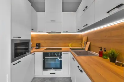 a kitchen with white cabinets and a sink at - The Blue Apartment - 1BD with Artistic Interior Design by Flat Mаnager in Sofia