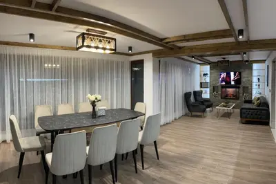 a dining room with a table and chairs at 4U LUXURY VILLA in Dospat