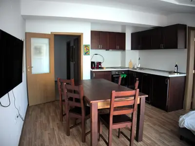 a kitchen and dining room with a table and chairs at ParkView Complex Large Flat Next to Ski Lift in Bansko