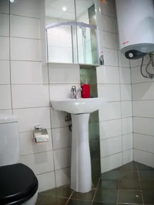 a bathroom with a sink and a toilet and a mirror at ParkView Complex Large Flat Next to Ski Lift in Bansko