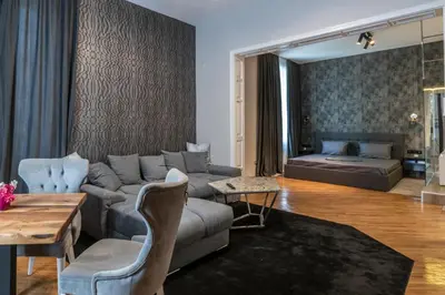 a living room with a couch and a table at Luxury Vitosha Apartment in Sofia