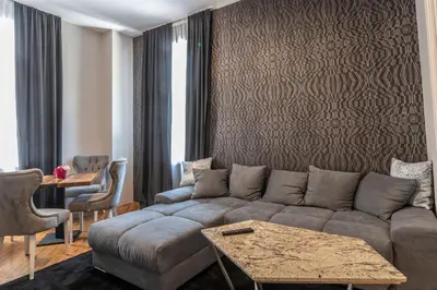 a living room with a couch and a table at Luxury Vitosha Apartment in Sofia