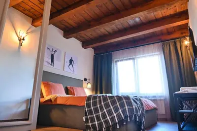 a bedroom with a bed and a window at Marand Villas in Bansko