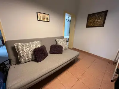 a couch with three pillows on it in a room at 113 in Sofia with 2BR and 2 full bath in Sofia