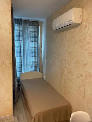 a small room with a bed and a air conditioner at Colonel apartment 938 in Sofia