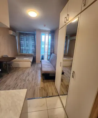 a living room with a mirror and a couch at Colonel apartment 944 in Sofia