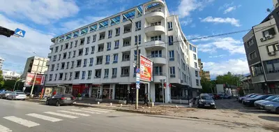 a large white building on the corner of a street at Colonel apartment 945 in Sofia