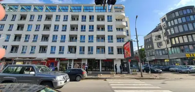 a large white building with cars parked in front of it at Colonel apartment 946 in Sofia