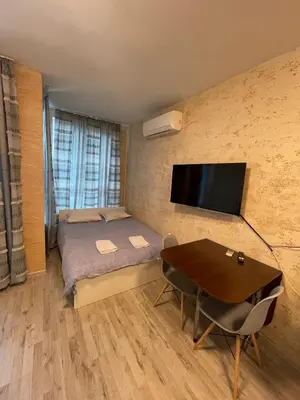 a small room with a bed and a table at Colonel apartment 947 in Sofia