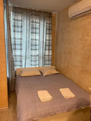 a bed in a room with a window with towels on it at Colonel apartment 947 in Sofia