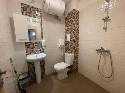 a bathroom with a toilet and a sink and a shower at Colonel apartment 958 in Sofia
