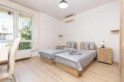 a white room with two beds and a window at Stylish 2BD Apartment with a Nice Cozy Terrace by Flat Mаnager in Plovdiv