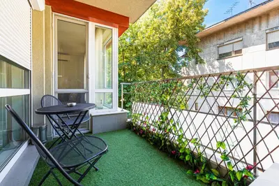 a patio with a table and chairs on a balcony at Stylish 2BD Apartment with a Nice Cozy Terrace by Flat Mаnager in Plovdiv