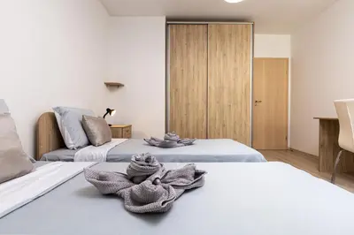 a room with two beds with towels on them at Stylish 2BD Apartment with a Nice Cozy Terrace by Flat Mаnager in Plovdiv