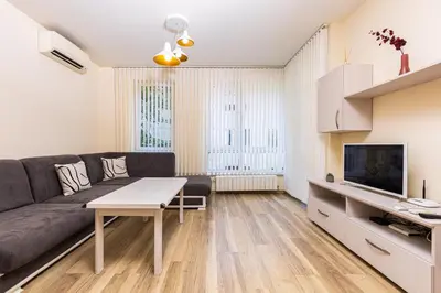 a living room with a couch and a tv at Stylish 2BD Apartment with a Nice Cozy Terrace by Flat Mаnager in Plovdiv