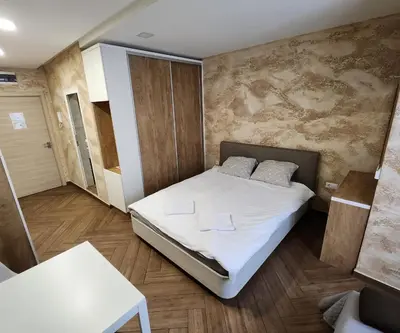 a small room with a bed and a table at Colonel apartment Luxury in Sofia