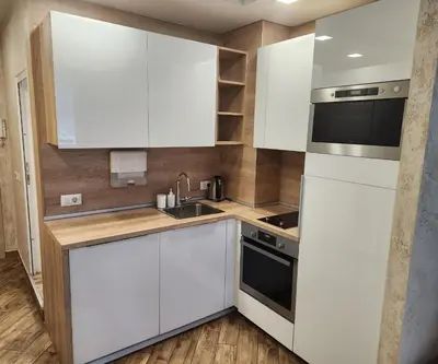 a kitchen with white cabinets and a sink at Colonel apartment Diamond in Sofia