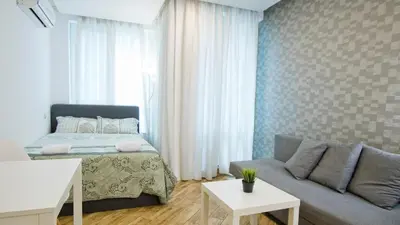 a living room with a bed and a couch at Colonel apartment Bijou in Sofia