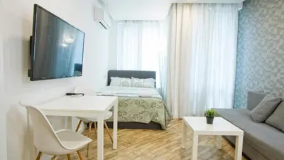 a small living room with a bed and a couch at Colonel apartment Bijou in Sofia