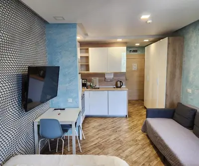 a living room with a couch and a table and a kitchen at Colonel apartment Relax in Sofia