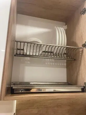 a kitchen with plates and utensils on a shelf at Colonel apartment Royal in Sofia