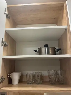 a kitchen shelf with glasses and a pot on it at Colonel apartment Royal in Sofia