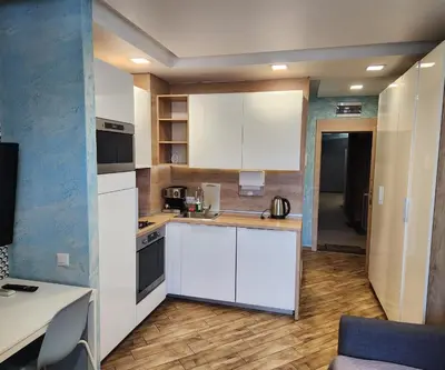 a kitchen with white cabinets and a counter top at Colonel apartment Select in Sofia