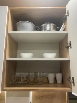 a cabinet with some bowls and cups in it at Colonel apartment Select in Sofia