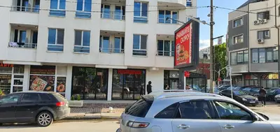 two cars parked on a street in front of a building at Colonel apartment 937 in Sofia
