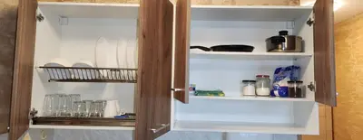 a cupboard with dishes and other items in it at Colonel apartment 941 in Sofia