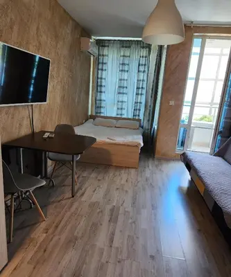 a small room with a bed and a table and a tv at Colonel apartment 953 in Sofia