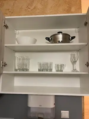a kitchen shelf with glasses and a pot on it at Colonel apartment 955 in Sofia