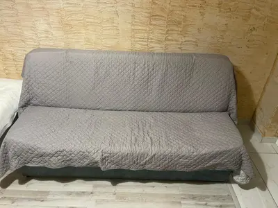 a gray couch sitting next to a wall at Colonel apartment 959 in Sofia