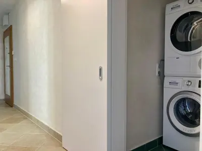 a washing machine and a washer and dryer in a room at Orfey Apartment in Sofia