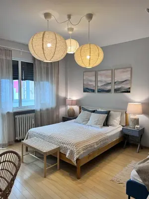 a bedroom with a bed and two lamps and two chairs at S íRMA Apartment - The Soul of Central Sofia in Sofia