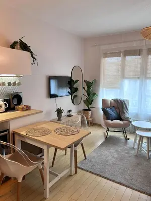 a living room with a table and a couch at S íRMA Apartment - The Soul of Central Sofia in Sofia
