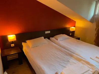 a bedroom with a large white bed with two pillows at 7 apartments in Alexander complex in Bansko