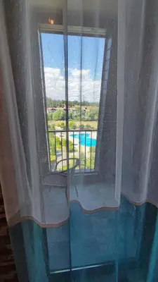 a room with a window with a view of a pool at Aspen Valley Studio Apartment Аспен Вали студио апартамент in Razlog