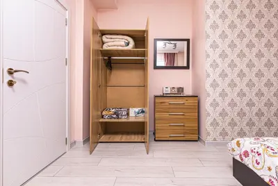 a bedroom with a bed and a dresser and a closet at Bright Modern 2BD Apartment with Panoramic View by Flat Mаnager in Plovdiv