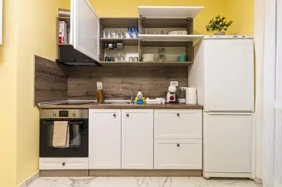 a kitchen with white cabinets and a white refrigerator at Bright Modern 2BD Apartment with Panoramic View by Flat Mаnager in Plovdiv
