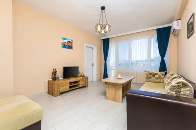a living room with a couch and a television at Bright Modern 2BD Apartment with Panoramic View by Flat Mаnager in Plovdiv