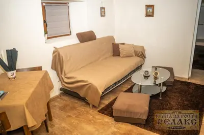 a living room with a couch and a table at Къща за гости Рупите , Guest House Relax Rupite in Rupite