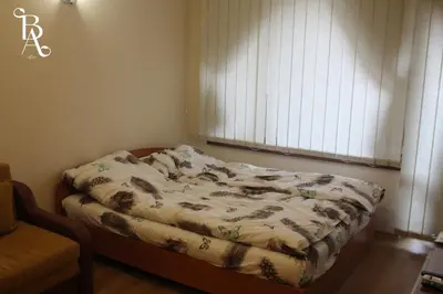 a bed sitting in a room with a window at Bansko Apart in Bansko