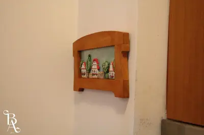 a shelf on a wall with four ketchup bottles at Bansko Apart in Bansko