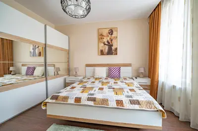 a bedroom with a bed and a mirror at MARSY in Sandanski