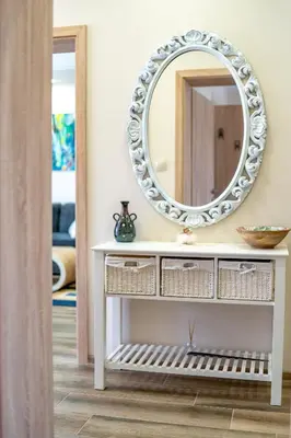 a mirror on top of a white dresser in a room at MARSY in Sandanski