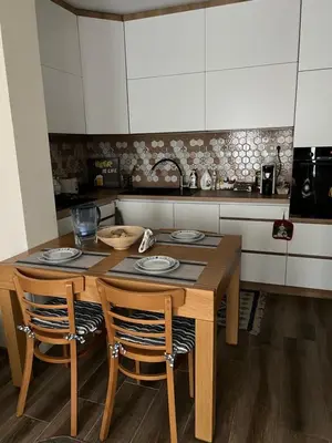 a kitchen with a wooden table and two chairs at MARSY in Sandanski