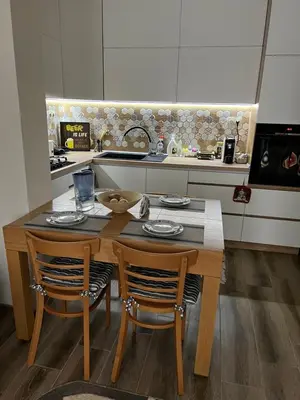 a kitchen with a wooden table and two chairs at MARSY in Sandanski